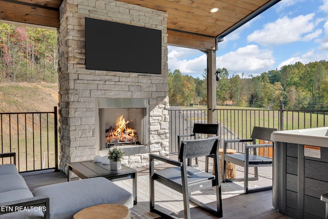 deck featuring an outdoor living space with a fireplace