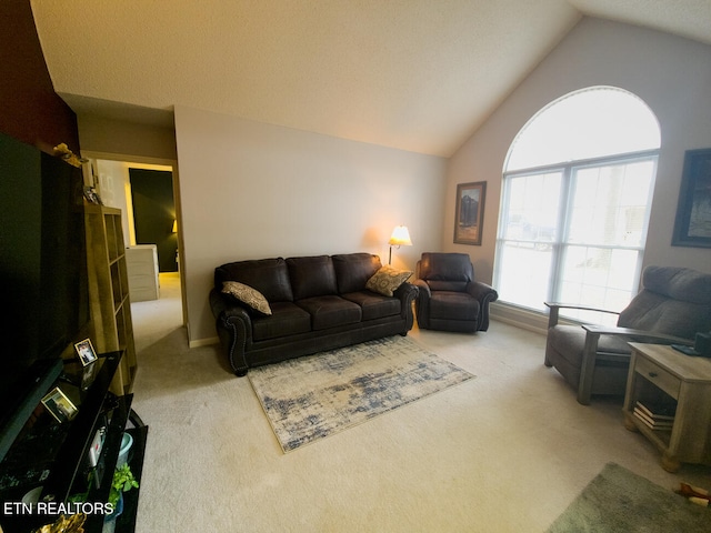 carpeted living room with vaulted ceiling