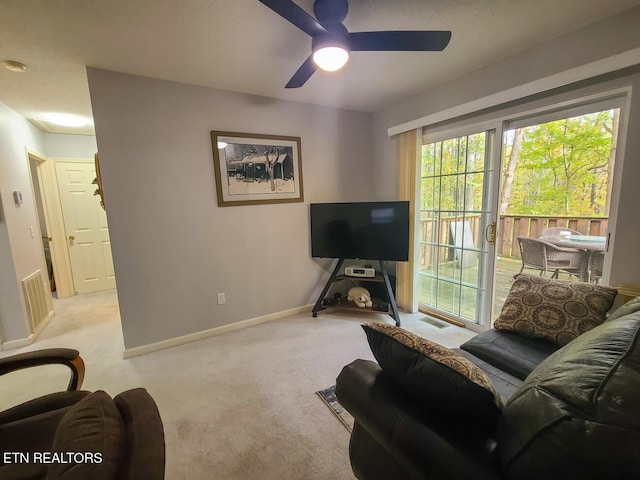 carpeted living room featuring ceiling fan