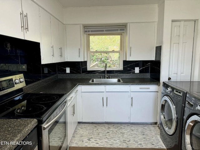 kitchen with sink, independent washer and dryer, stainless steel electric stove, decorative backsplash, and white cabinets