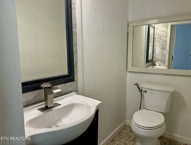 bathroom with tile patterned floors, toilet, and sink