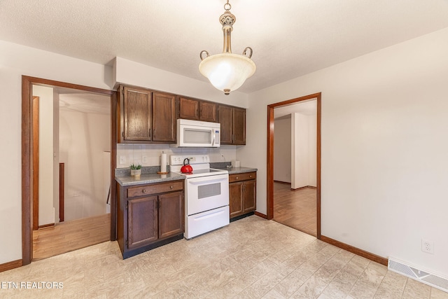 kitchen with tasteful backsplash, a textured ceiling, pendant lighting, white appliances, and light hardwood / wood-style flooring