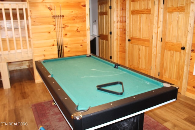 rec room with hardwood / wood-style flooring, wooden walls, and billiards