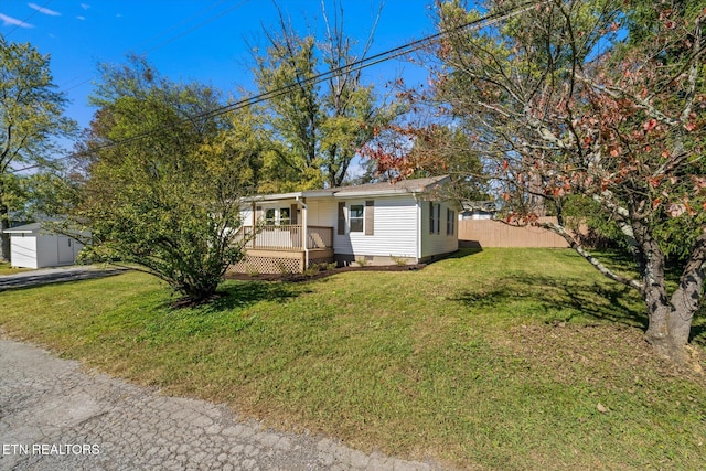 view of front of house featuring a storage shed and a front lawn