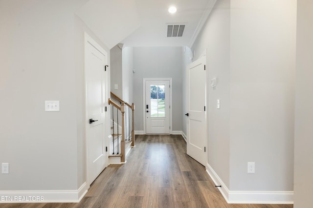 doorway featuring crown molding and wood-type flooring