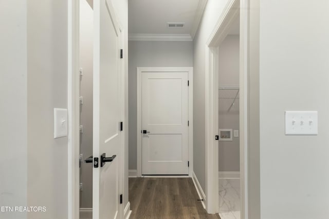 hallway featuring ornamental molding and dark wood-type flooring