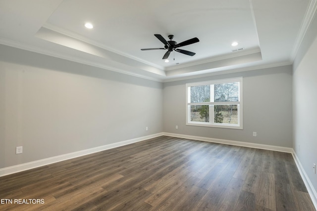 unfurnished room with dark hardwood / wood-style flooring, ceiling fan, a raised ceiling, and crown molding