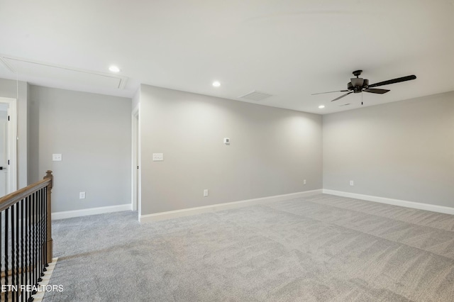 empty room featuring ceiling fan and light colored carpet