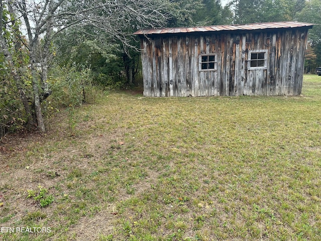 view of outdoor structure with a lawn