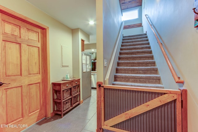 stairway featuring tile patterned floors