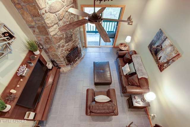 living room featuring a high ceiling and ceiling fan