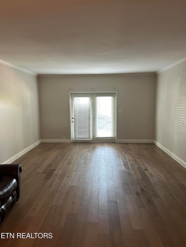 empty room with crown molding and dark hardwood / wood-style floors