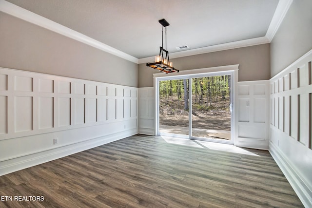 unfurnished dining area featuring crown molding, a notable chandelier, and dark hardwood / wood-style floors