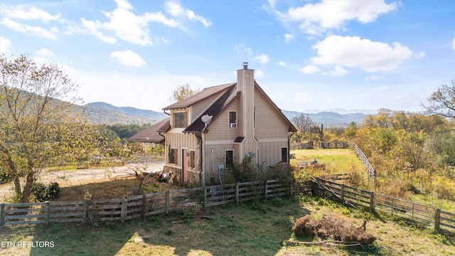 view of home's exterior featuring a mountain view and a rural view