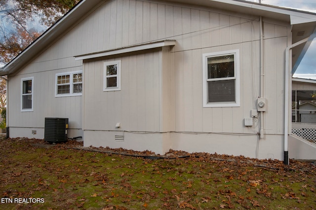 view of side of home with central air condition unit