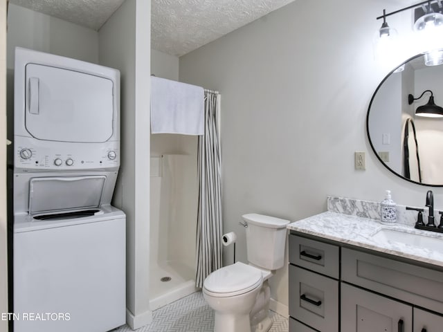 bathroom featuring curtained shower, stacked washer / dryer, a textured ceiling, toilet, and vanity