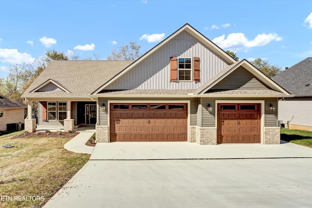 craftsman inspired home with central AC, a garage, and a front lawn