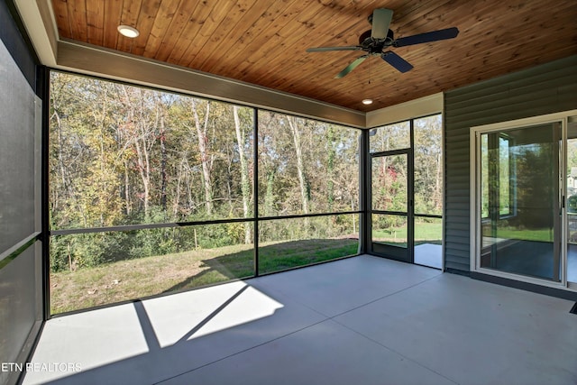 unfurnished sunroom featuring wood ceiling and ceiling fan