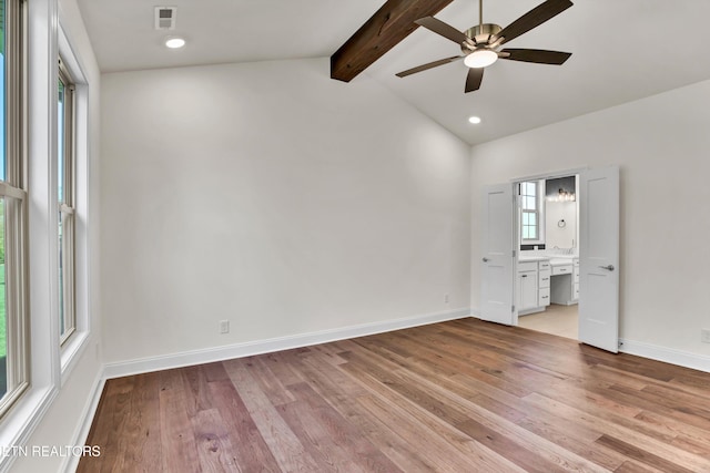 unfurnished room featuring light hardwood / wood-style floors, vaulted ceiling with beams, and ceiling fan