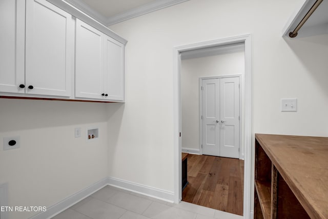 clothes washing area featuring cabinets, hookup for a washing machine, ornamental molding, light hardwood / wood-style floors, and hookup for an electric dryer