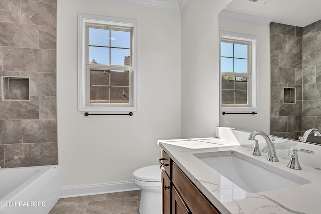 bathroom featuring vanity, toilet, crown molding, and plenty of natural light