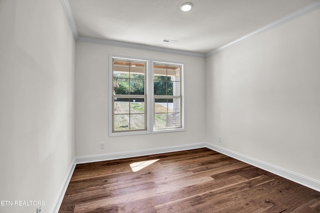 unfurnished room featuring ornamental molding and hardwood / wood-style flooring