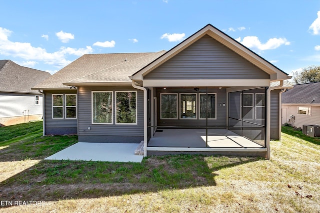 back of property with a yard, a sunroom, central AC unit, a patio area, and ceiling fan