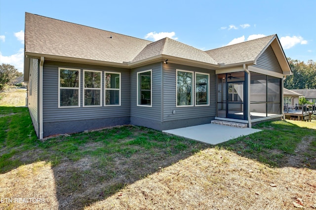 back of house featuring a yard and a sunroom