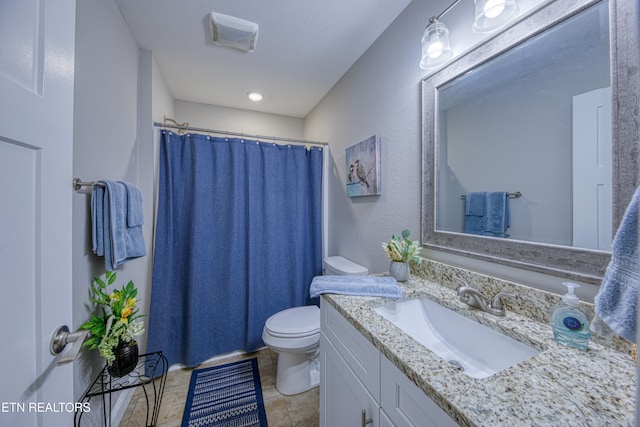 bathroom featuring vanity, toilet, tile patterned floors, and a shower with curtain