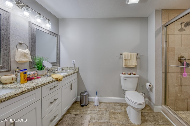 bathroom with toilet, a textured ceiling, walk in shower, and vanity