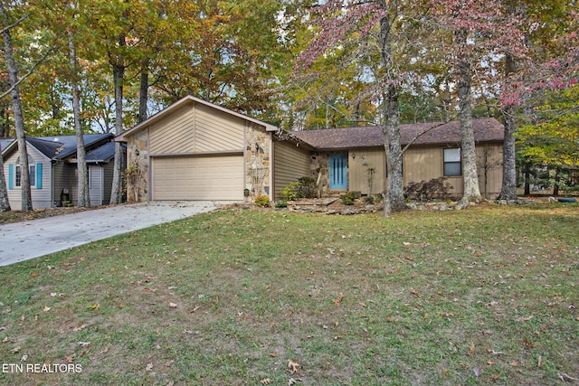 single story home featuring a garage and a front yard