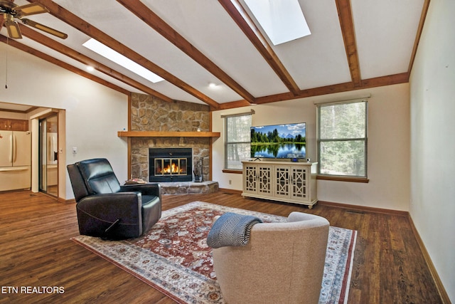 living room with a fireplace, ceiling fan, dark hardwood / wood-style flooring, and lofted ceiling with skylight