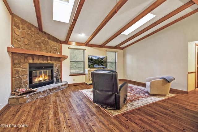 living room with a fireplace, wood-type flooring, and lofted ceiling with skylight