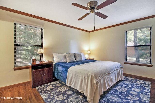 bedroom featuring ceiling fan, ornamental molding, and dark hardwood / wood-style flooring