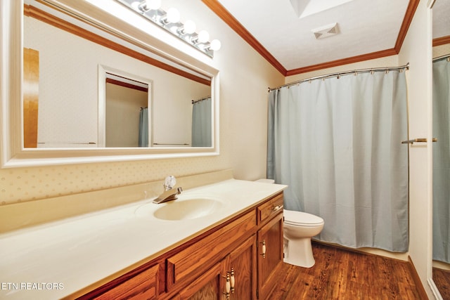 bathroom with toilet, hardwood / wood-style flooring, vanity, and ornamental molding