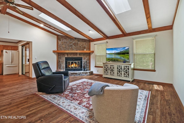 110 Trafalgar Dr, Fairfield Glade, TN 38558 - living room with a ceiling fan, wood finished floors, a stone fireplace, baseboards, and lofted ceiling with beams