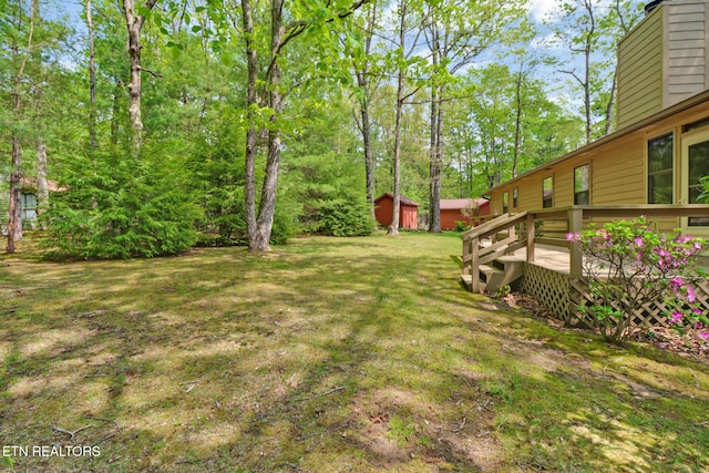 110 Trafalgar Dr, Fairfield Glade, TN 38558 - view of yard featuring a storage unit, a wooden deck, and an outbuilding