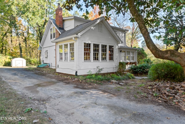 view of property exterior with a shed