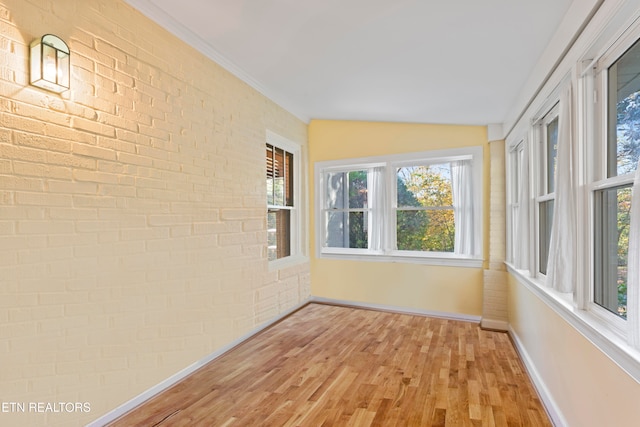 unfurnished sunroom with a healthy amount of sunlight and vaulted ceiling