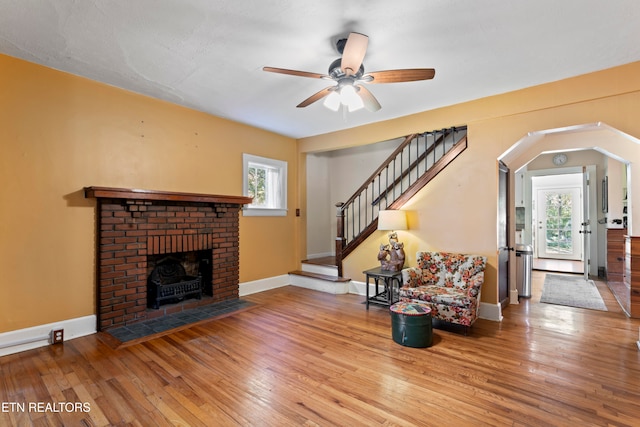 living room featuring ceiling fan and wood-type flooring