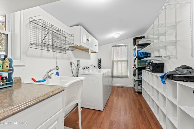 washroom featuring cabinets, dark hardwood / wood-style floors, and separate washer and dryer