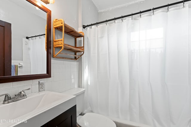 full bathroom with vanity, shower / tub combo with curtain, and toilet