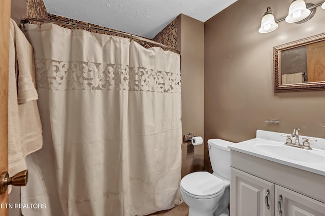 bathroom with tile patterned floors, toilet, a shower with shower curtain, vanity, and a textured ceiling