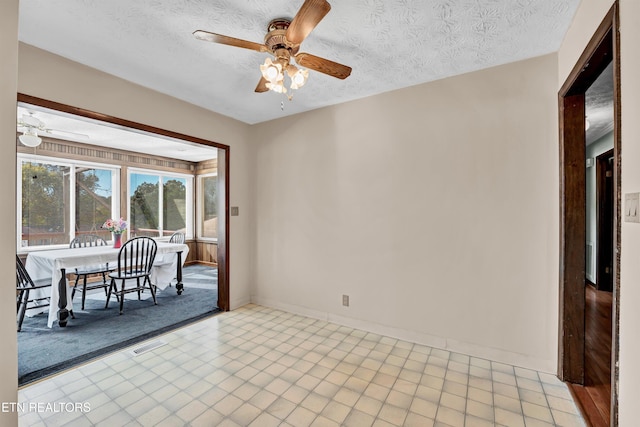 unfurnished room with a textured ceiling and ceiling fan