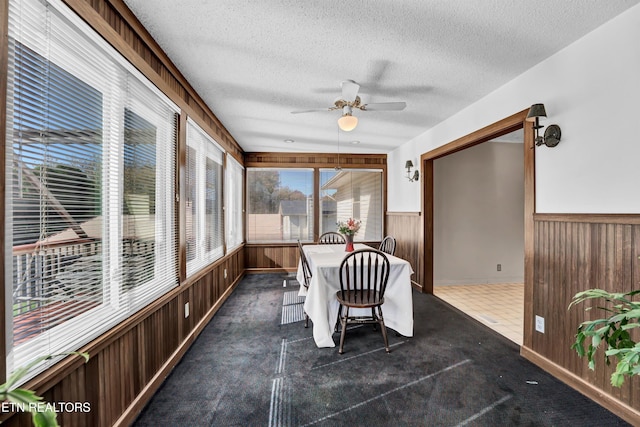 unfurnished sunroom with ceiling fan