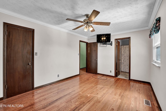 unfurnished bedroom featuring ceiling fan, crown molding, a textured ceiling, and light wood-type flooring