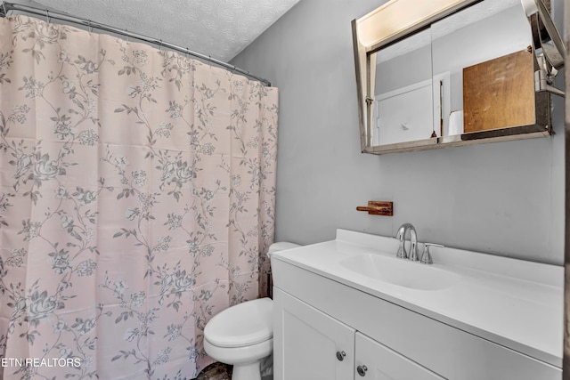 bathroom featuring vanity, a shower with shower curtain, a textured ceiling, and toilet