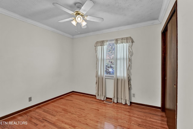 interior space featuring light hardwood / wood-style floors, a textured ceiling, ornamental molding, and ceiling fan