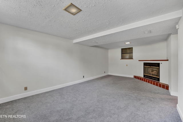 basement with carpet and a textured ceiling