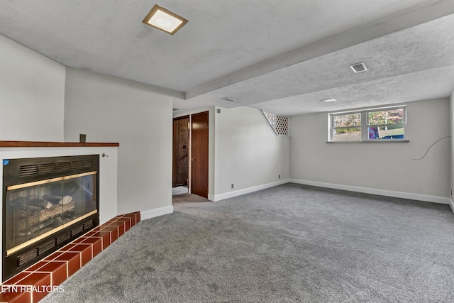 living room with a textured ceiling, carpet floors, and a tile fireplace